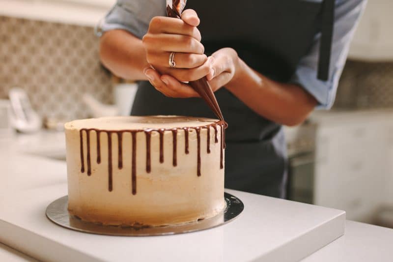 Baker decorating a cake